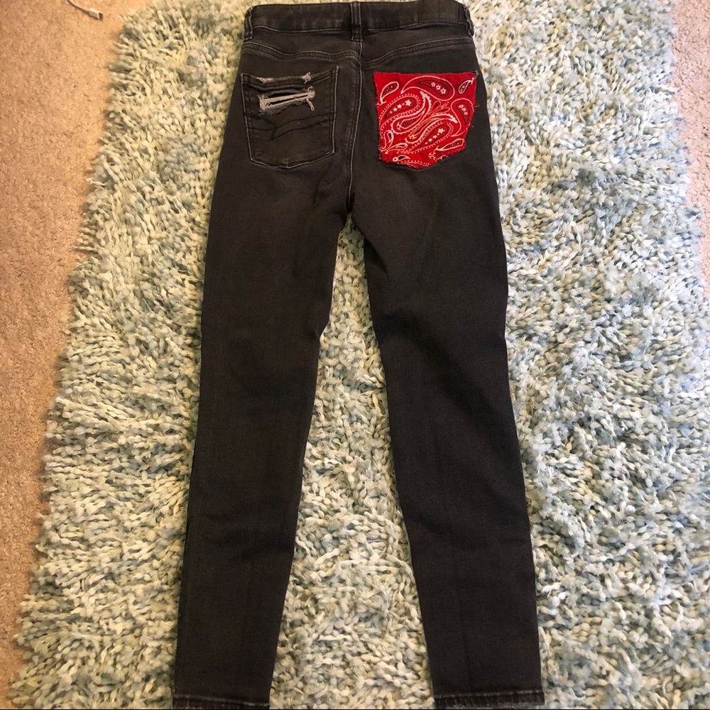 Light wash black jeans with red bandana pocket